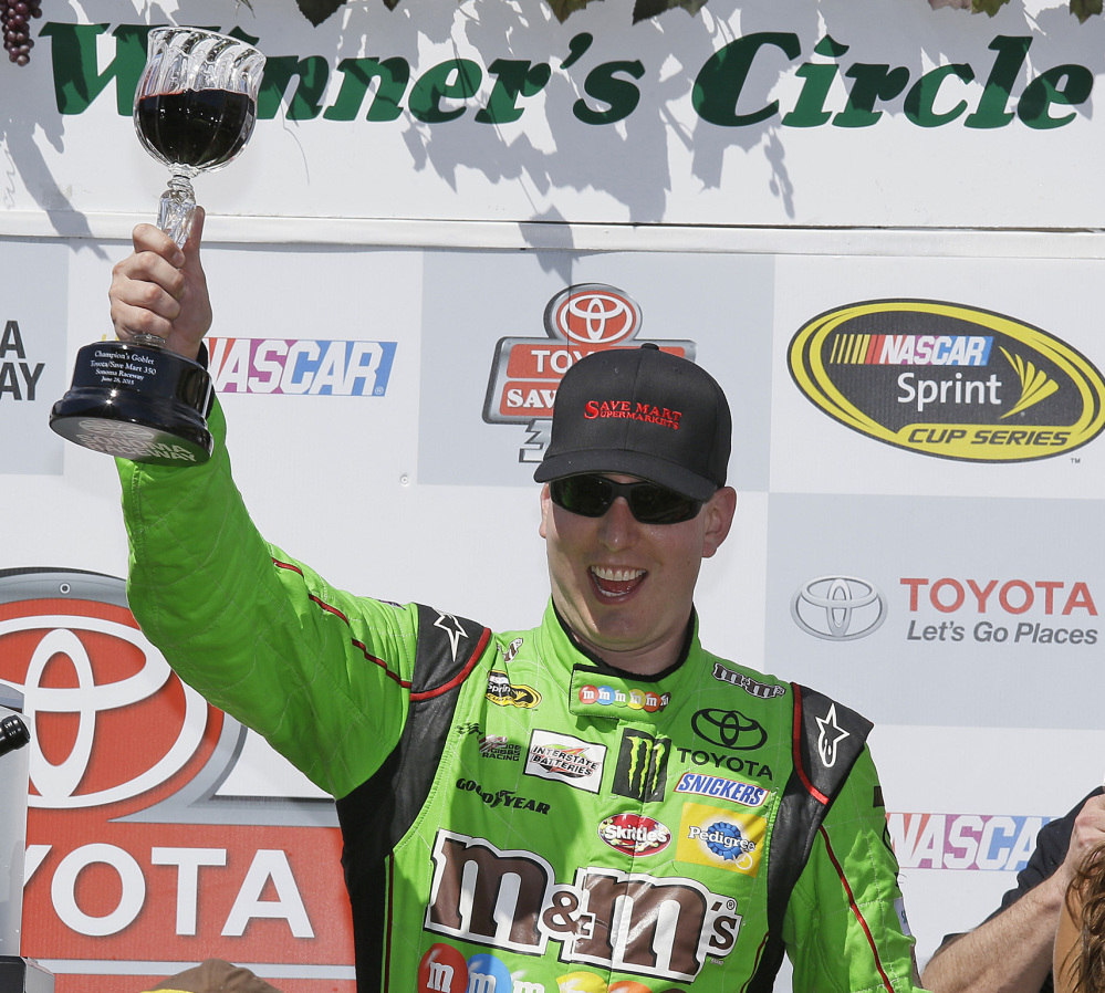 Kyle Busch celebrates after a win that boosted his chances of qualifying for the Chase of the Sprint Cup championship.