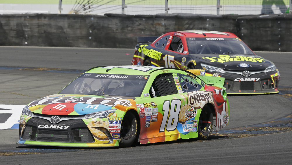 Kyle Busch leads Clint Bowyer through a turn during Sunday’s Sprint Cup race on the road course at Sonoma Raceway in California. Busch, who missed the first 11 races of the season because of a broken leg, earned his first victory since March.