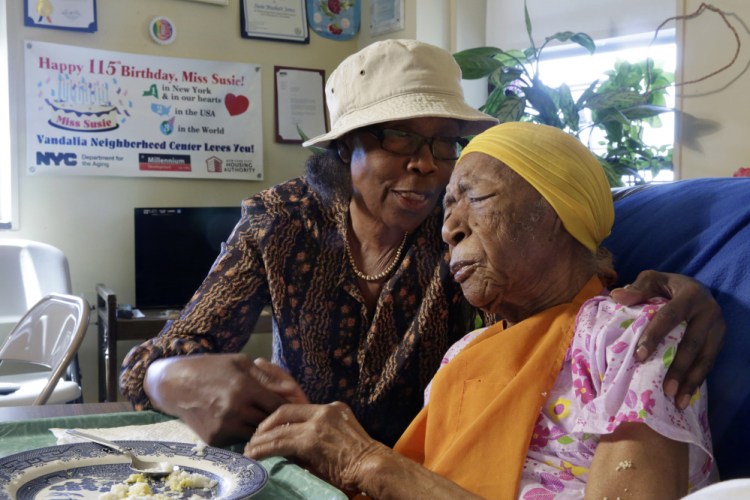 Susannah Mushatt Jones, 115, is embraced by her niece Lois Judge in her room at the Vandalia Avenue Houses in Brooklyn, N.Y.