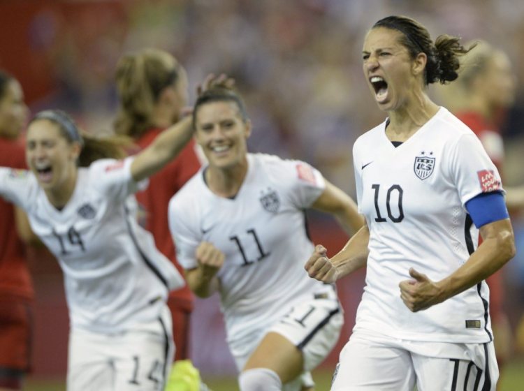 The United States’ Carli Lloyd (10) celebrates with teammates Ali Krieger (11) and Morgan Brian after scoring on a penalty kick against Germany during the second half of the Women’s World Cup semifinal match Tuesday night in Montreal.