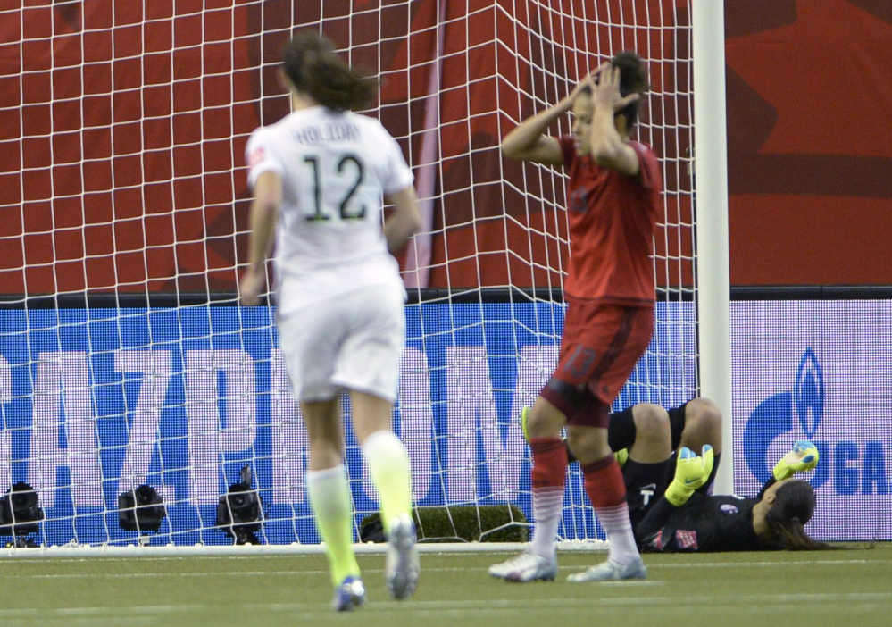 Germany’s Celia Sasic (13) reacts after missing a penalty kick against U.S. keeper Hope Solo in the second half Tuesday night in Montreal. Germany had been 17 for 17 on World Cup penalty kicks.