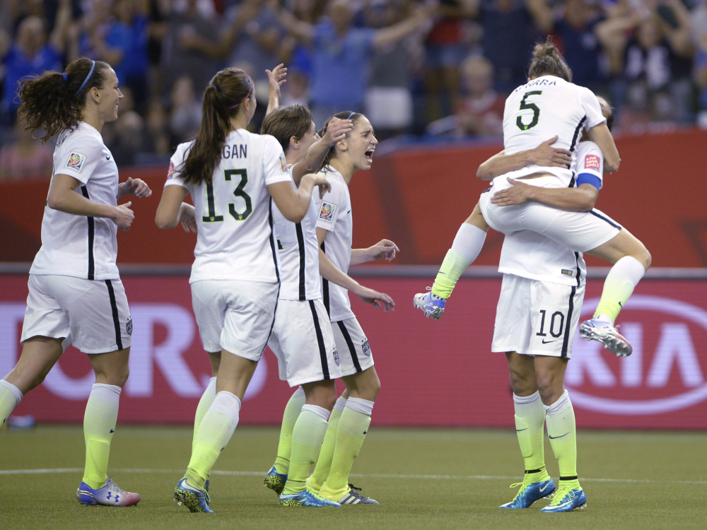 Kelly O’Hara (5) of the United States jumps into the arms of Carli Lloyd after O’Hara scored against Germany in the second half of their semifinal win in the Women’s World Cup soccer tournament. The goal gave the U.S. a 2-0 lead that it never gave up.