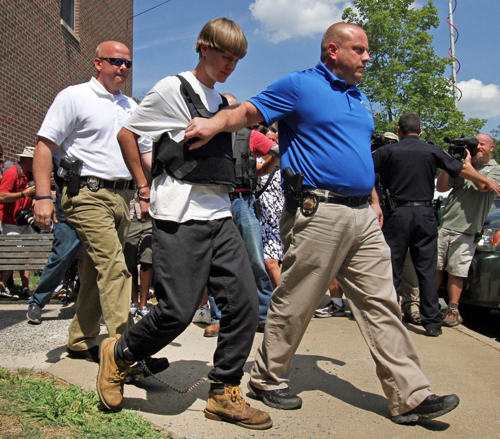 Charleston, S.C., shooting suspect Dylann Storm Roof, second from left, is escorted from the Shelby Police Department  in Shelby, N.C., Thursday. Roof is a suspect in the shooting of several people Wednesday night at the historic The Emanuel African Methodist Episcopal Church in Charleston, S.C. 