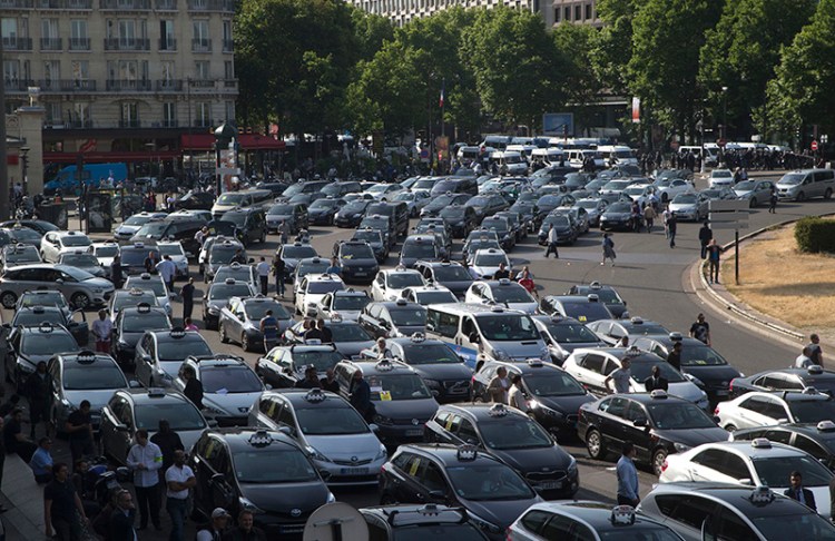 Taxis block a major entrance to Paris in protest over Uber.