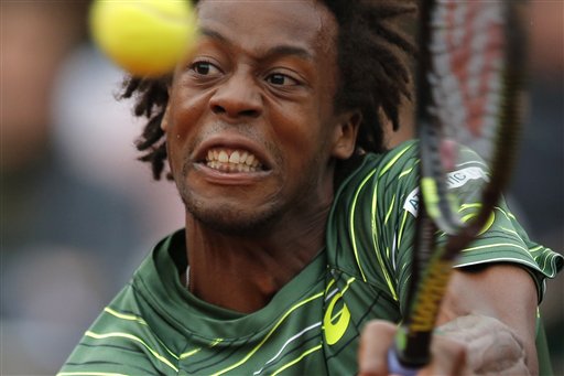 France's Gael Monfils plays a shot against Switzerland's Roger Federer in their fourth-round match in the French Open at Roland Garros stadium in Paris on Sunday. The Associated Press