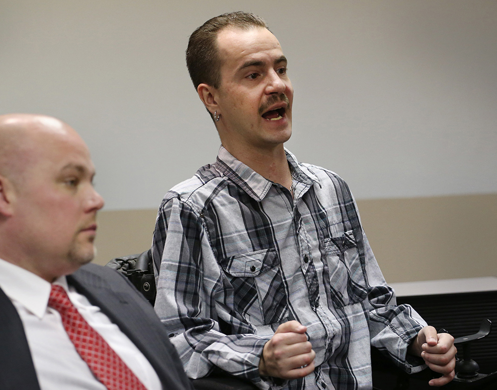 In this 2013 photo, Brandon Coats talks about the ruling that upheld his being fired after testing positive for the use of medical marijuana. His attorney, Michael Evans, is at left. The Associated Press