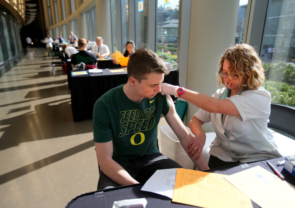Pharmacist Jenna Wright administers the meningitis B vaccine to University of Oregon freshman Drew Russert during a vaccination clinic in March after an outbreak of meningococcemia. On Wednesday, a federal panel gave a weak endorsement to two new expensive meningitis shots, declining to recommend the vaccines for all teenagers and leaving the decision to parents and doctors.
The Associated Press