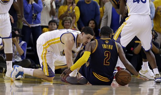 Cleveland guard Kyrie Irving tries to control the ball next to Golden State guard Klay Thompson during overtime of Game 1 of the NBA Finals in Oakland, Calif., on Thursday. Irving left the game with a fractured left kneecap right after this play. The Associated Press