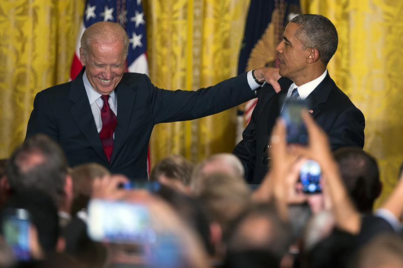 Vice President Joe Biden and President Barack Obama react after a heckler was removed from the East Room of the White House during remarks at a reception to celebrate LGBT Pride Month.