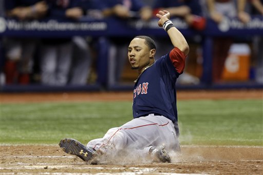 Red Sox center fielder Mookie Betts scores the winning run against the Tampa Bay Rays on Friday. The Associated Press