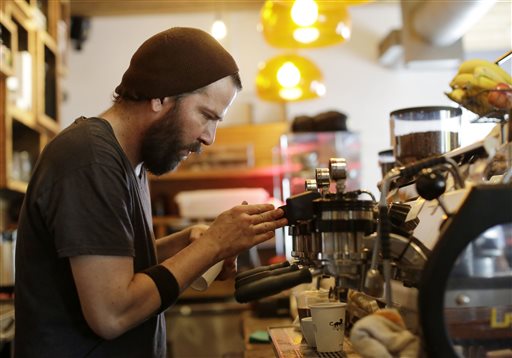 Employee J.P. Aristizabal prepares coffee drinks recently at Panther Coffee, an independently owned coffee retailer and wholesaler in Miami. Over the past year, restaurant and bar receipts for the nation as a whole have surged 8.2 percent. The Associated Press
