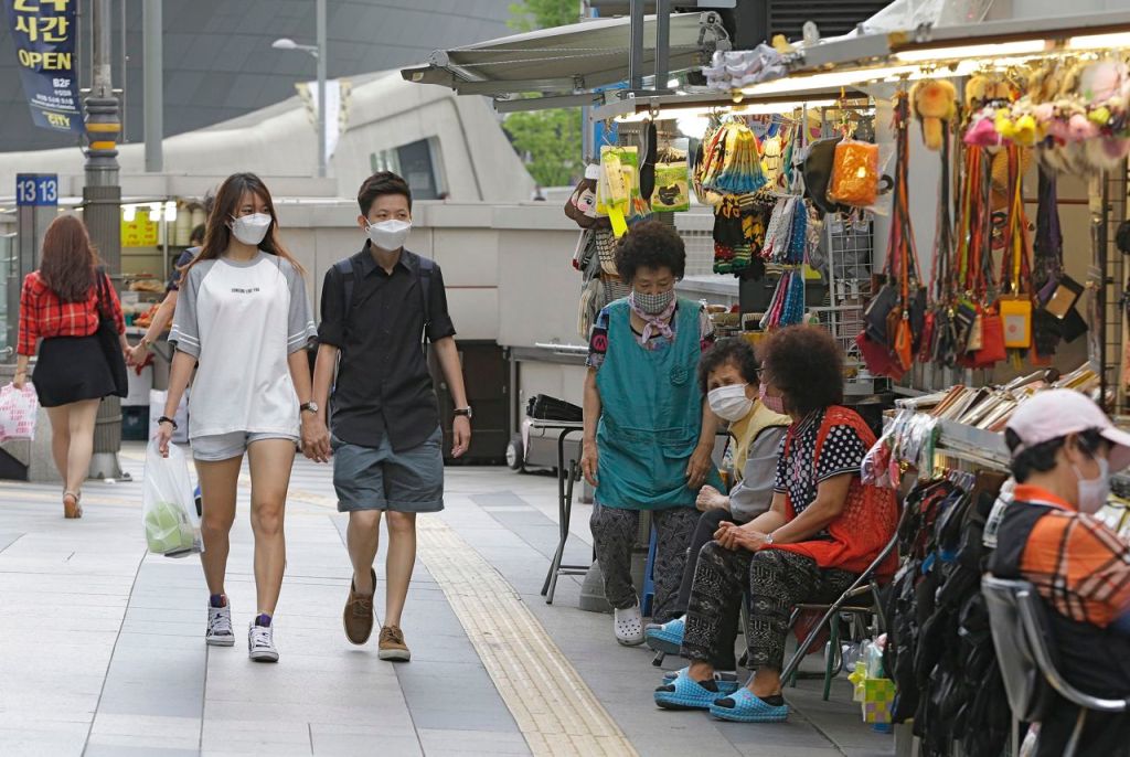 A couple wears masks as a precaution against MERS – Middle East Respiratory Syndrome – at a market in Seoul, South Korea, Thursday. The Associated Press