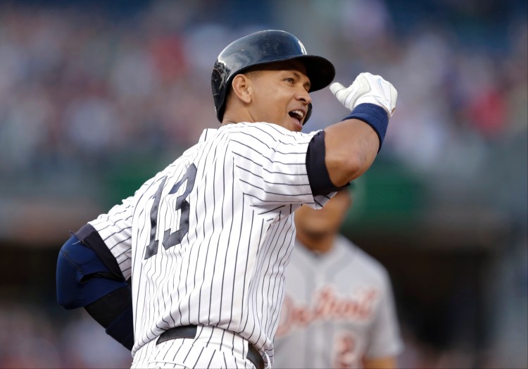 The New York Yankees' Alex Rodriguez gestures to the crowd after hitting a home run for his 3,000th career hit in the first inning of Friday night's game against the Detroit Tigers in New York.
The Associated Press