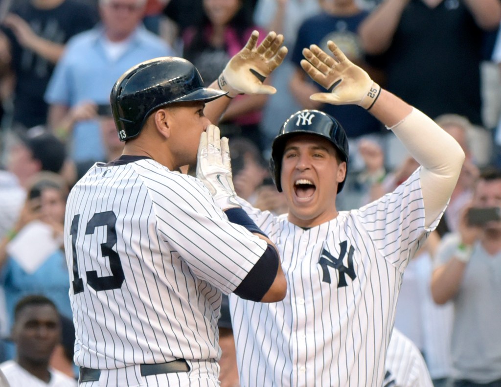 Alex Rodriguez (13) celebrates with Mark Teixeira after hitting a home run in the first inning Friday against the Detroit Tigers. The home run was his 3,000th career hit.
The Associated Press