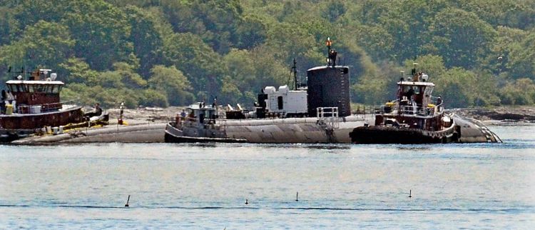 Tugs assist as the former USS Miami nuclear-powered submarine is towed from the Portsmouth Nasal Shipyard in Kittery on June 12, 2015. U.S. Navy photo via AP
