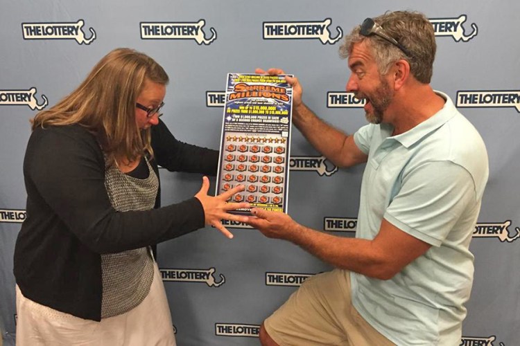 Stacy and David Foster, of Orleans, Massachusetts, ham it up as they collect their winnings in this  Massachusetts Lottery Commission photo.