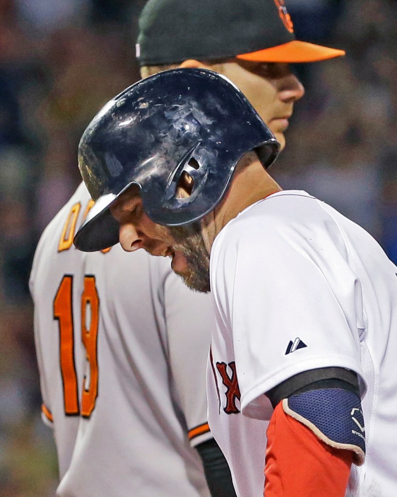 Dustin Pedroia grimaces after injuring his hamstring rounding first base on a single in the sixth inning against the Orioles at Fenway Park on Wednesday. The Asxociated Press