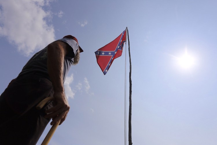 Robert Hersey of Gray displays a confederate flag to honor a Union soldier from Gray who died in the Civil War. Hersey doesn’t think the Confederate flag is racist, but he understands the criticism. 
Derek Davis/Staff Photographer