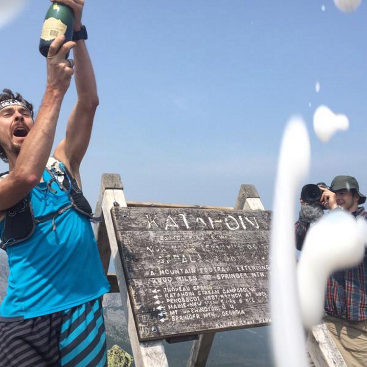 Scott Jurek's celebration at the top of Mount Katahdin led to charges of drinking in Baxter State Park, hiking with a group larger than 12 people and littering – when champagne sprayed into the air and hit the ground.
