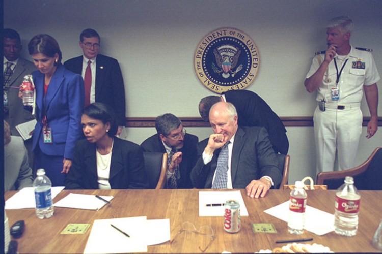The vice president’s top lawyer, David Addington (kneeling), conferred with Cheney. Addington would begin to secure the legal authority to respond to the attacks. Photo courtesy of PBS.org.
