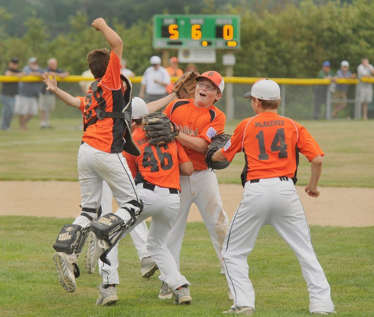Biddeford players rush the mound to celebrate their team's 5-0 win over Hall-Dale in the Maine Little League championship baseball game Thursday.