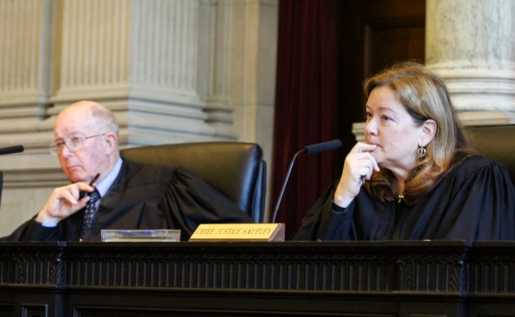 Chief Justice Leigh Saufley, right, joined by Justice Donald Alexander, listen to arguments before the Maine Supreme Judicial Court, Friday during a hearing on the issue of LePage's attempt to veto 65 bills after lawmakers said they already became law. Joel Page/Staff Photographer