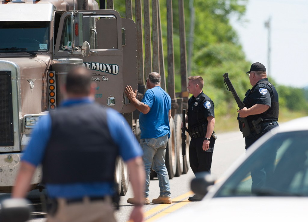 Lincoln police Chief Daniel Summers, right, and Officer Josh McKechnie inspect a logging truck leaving the town of Lee on Friday.
Kevin Bennett Photo