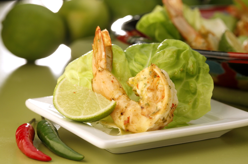 Shrimp are marinated in piri piri sauce, then quickly sauteed before being served in lettuce leaves with more of the spicy sauce.