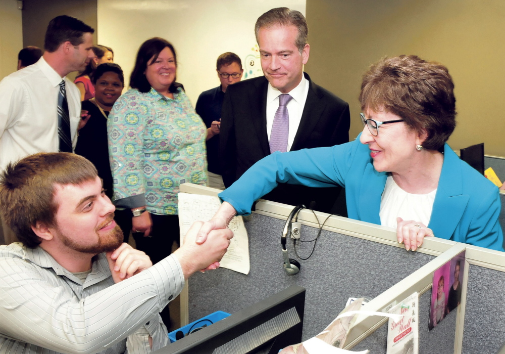U.S. Sen. Susan Collins greets Barclaycard employee Ben Tucker on Tuesday during a tour of the renovated call center in Wilton. Next to Collins is CEO Curt Hess.