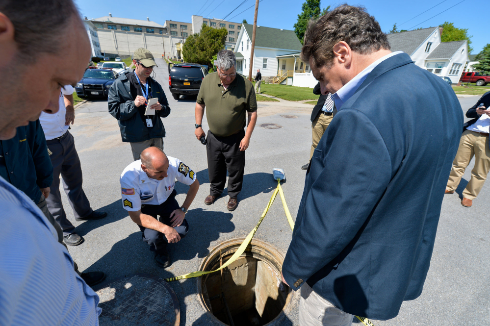 New York Gov. Andrew Cuomo’s office shows Cuomo, right, with Steven Racette, center, superintendent of Clinton Correctional Facility, looking at a manhole in Dannemora, N.Y., on June 6, before Racette was placed on administrative leave. A pair of inmates escaped through a manhole.
