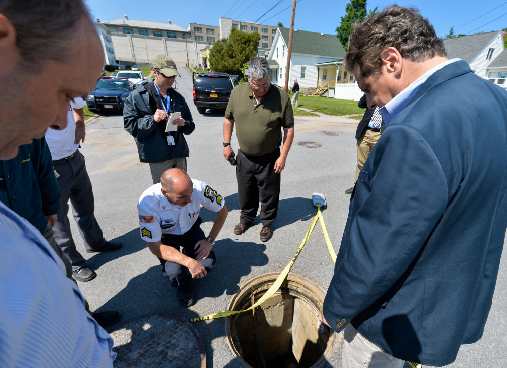 At left, Gov. Andrew Cuomo, right, and former prison Superintendent Steven Racette examine a manhole in Dannemora, N.Y., during the 23-day manhunt for David Sweat, above left, and Richard Matt.