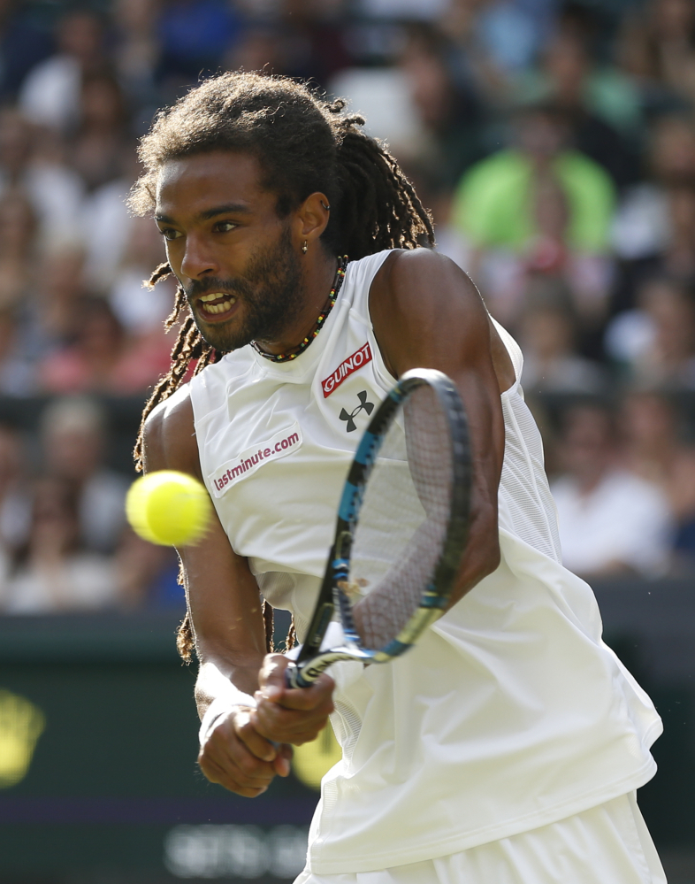 Dustin Brown of Germany returns a ball to Rafael Nadal of Spain during their singles match at the All England Lawn Tennis Championships in Wimbledon, London, on Thursday.