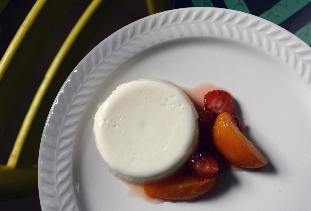 Panna cotta infused with apricot and cherry pits and served with apricot-strawberry compote.