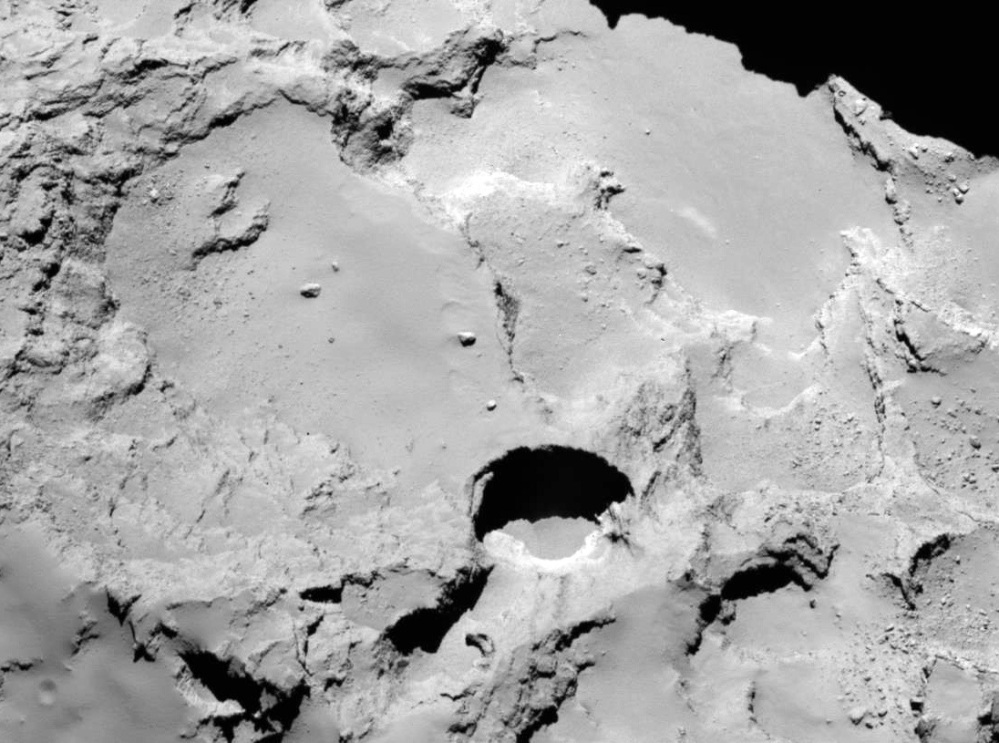 Photo made by the European Space Agency’s Rosetta spacecraft shows one of numerous sinkholes on comet 67P.