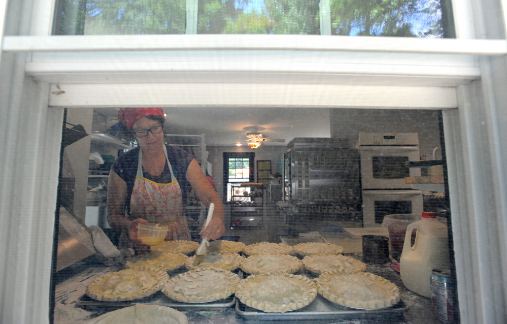 Shari Hamilton, owner of Hello Good Pie Co. Bakery, prepares a batch of pies for baking Thursday in Belgrade.