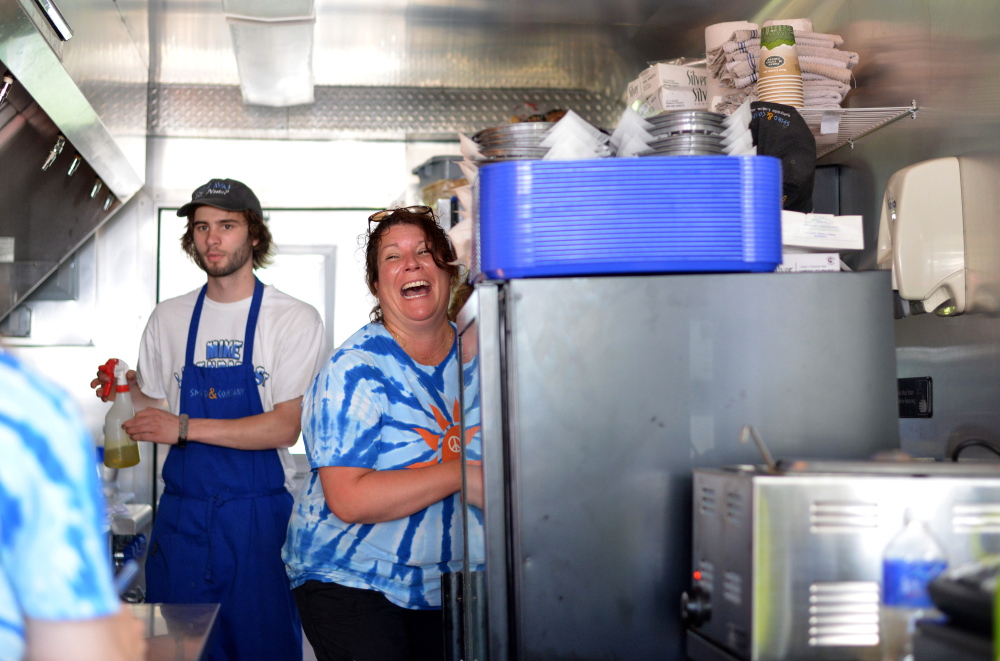 Lori Yotides laughs with her employees Thursday as they prepare for the afternoon rush at Spiro and Co. on Main Street in Belgrade Lakes.