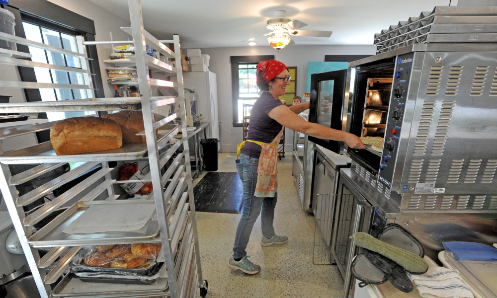 Shari Hamilton, owner of Hello Good Pie Co. Bakery, places a batch of pies in the oven Thursday at the new cafe in Belgrade Lakes.