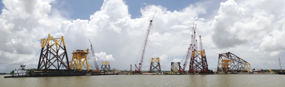 Structural components for Deepwater Wind are loaded onto barges in Houma, La., last week. The first barge is expected to arrive at Block Island, R.I., by mid-July, allowing workers to begin installing the massive foundations for the five-turbine, 30-megawatt facility.