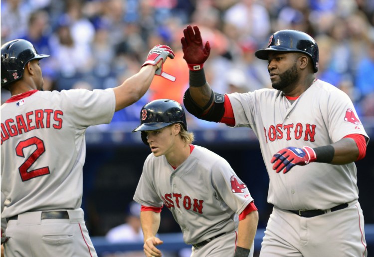 Boston Red Sox’s David Ortiz celebrates his three run home run against the Toronto Blue Jays with teammate Xander Bogaerts during the first inning of a baseball game, Thursday, July 2, 2015, 2015 in Toronto.  (Frank Gunn/The Canadian Press via AP)