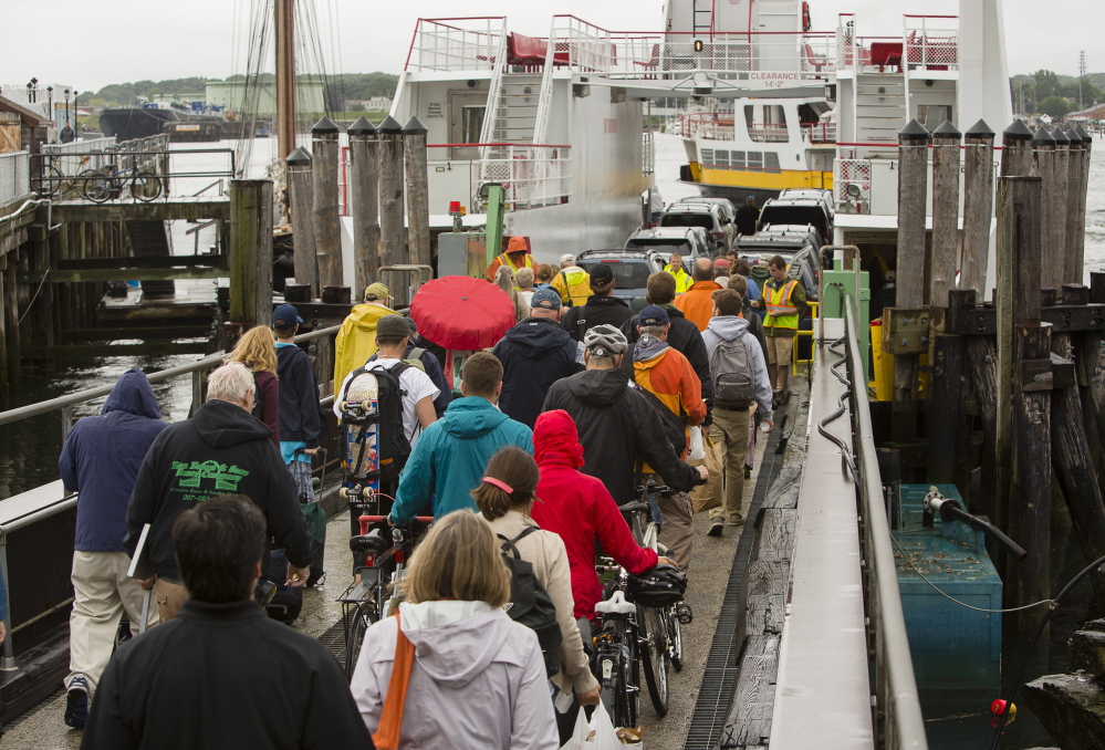 Passengers in Portland board the ferry to Peaks Island on Wednesday. “It’s really our busiest weekend of the year,” said Nick Mavodones, operations manager for Casco Bay Lines, which is adding extra trips for riders and cargo to the eight islands the ferry service accommodates.