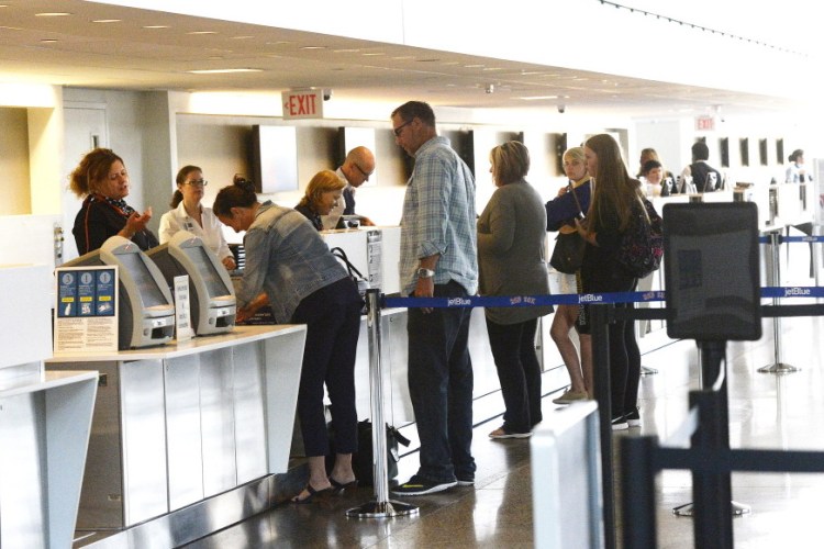 Passengers get tickets and check luggage Thursday at the Portland International Jetport. Snowstorms reduced the jetport’s passenger counts in February through March, but the arrival of good weather turned the trend around in May, which brought a 2.4 percent increase.