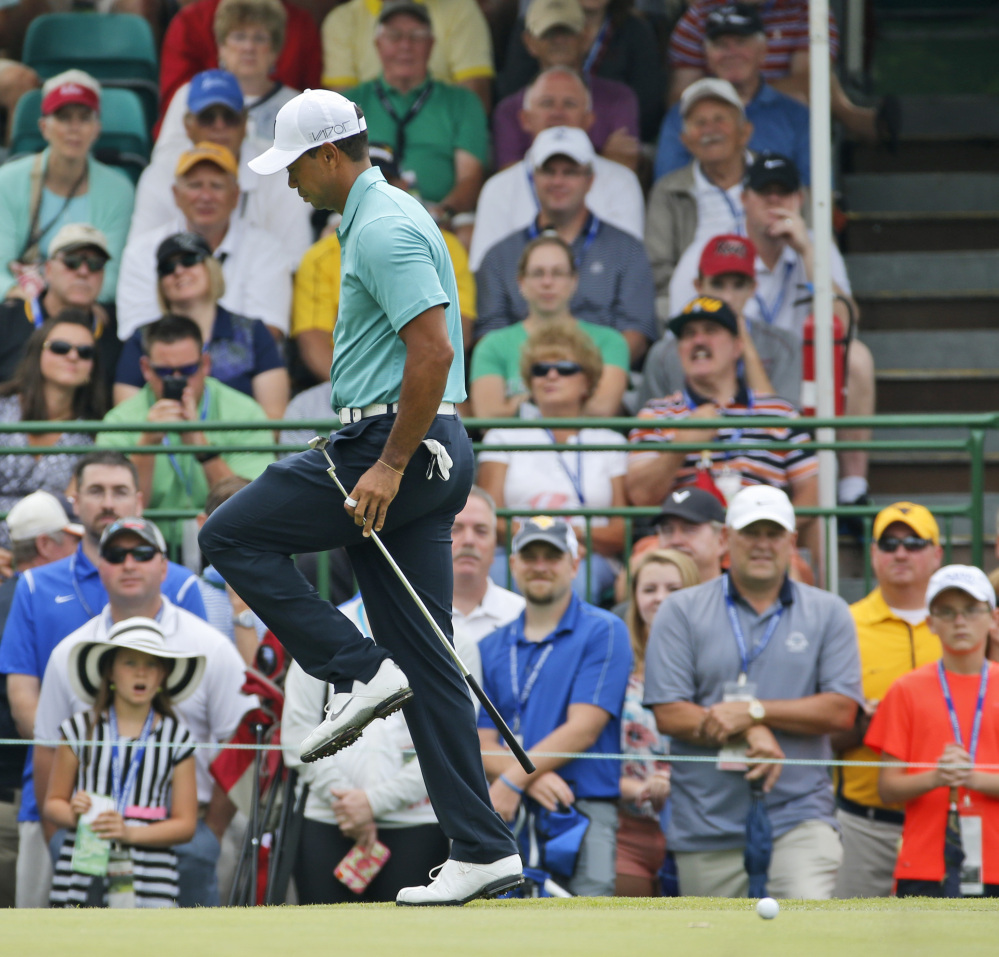 Tiger Woods reacts to a missed par putt on the 17th hole Thursday during the first round of the Greenbrier Classic golf tournament in West Virginia. Woods bogied the hole but still finished with a 66, four shots behind the leader, Scott Langley.