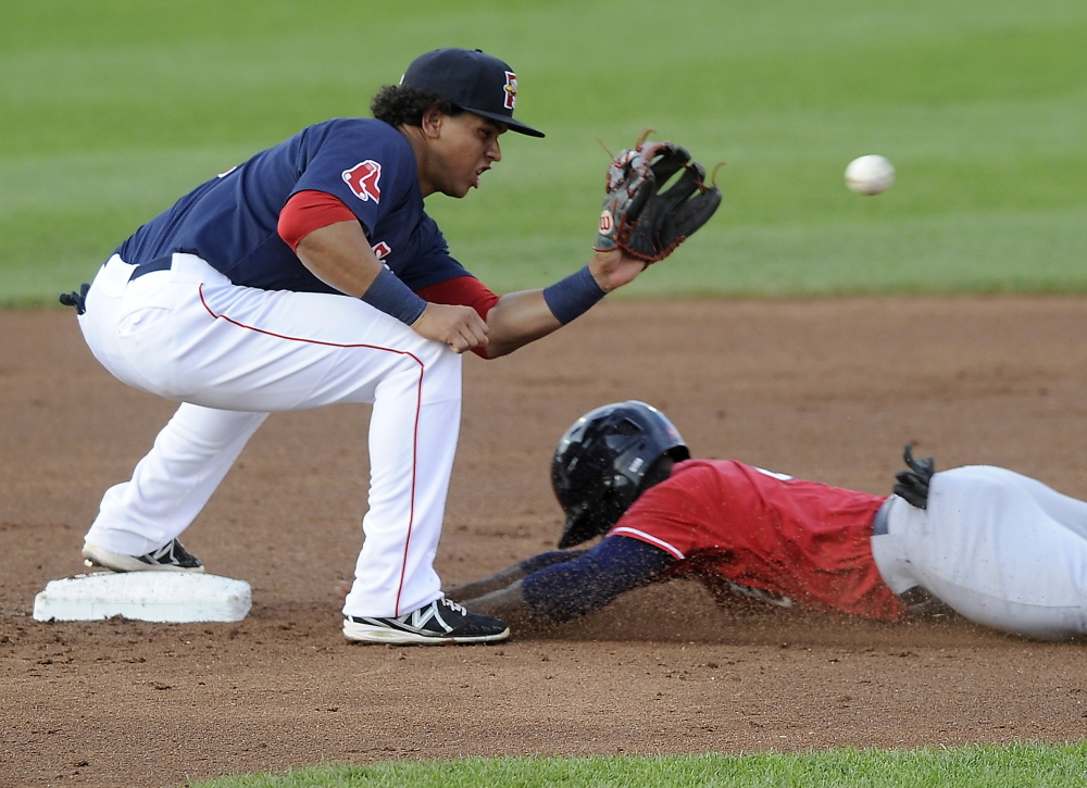 New Hampshire’s Roeman Fields steals second base as Portland shortstop Marco Hernandez receives the late throw. The Sea Dogs scored on a wild pitch in the 16th inning for a 6-5 victory at Hadlock Field.
