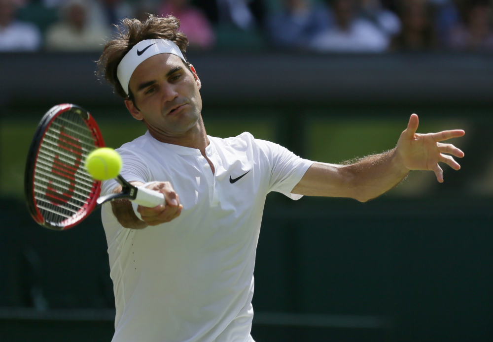 Roger Federer of Switzerland returns a shot to Sam Groth of Australia during their singles match at the All England Lawn Tennis Championships in Wimbledon, London, on Saturday.
