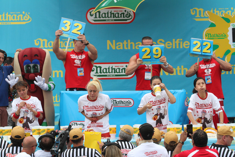 Competitors take part in Nathan’s Famous Fourth of July hot dog eating contest on Saturday in New York.