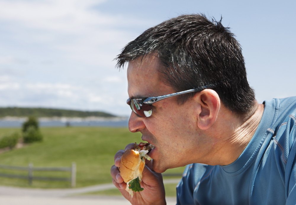 Steve Santiago samples a McDonald's lobster roll Thursday at Fort Williams Park in Cape Elizabeth.
Joel Page/Staff Photographer