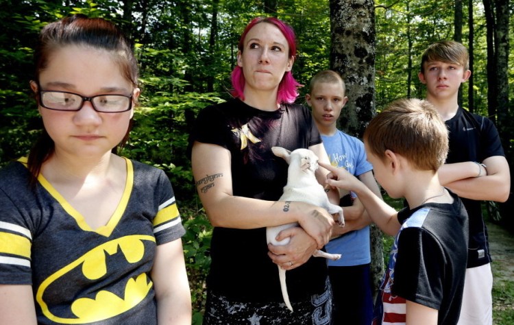 Jeanine Lent, center, who lives with her family on Bonny Eagle Road in Standish, was handcuffed for 45 minutes, along with her mother and husband Sunday.
Derek Davis/Staff Photographer
