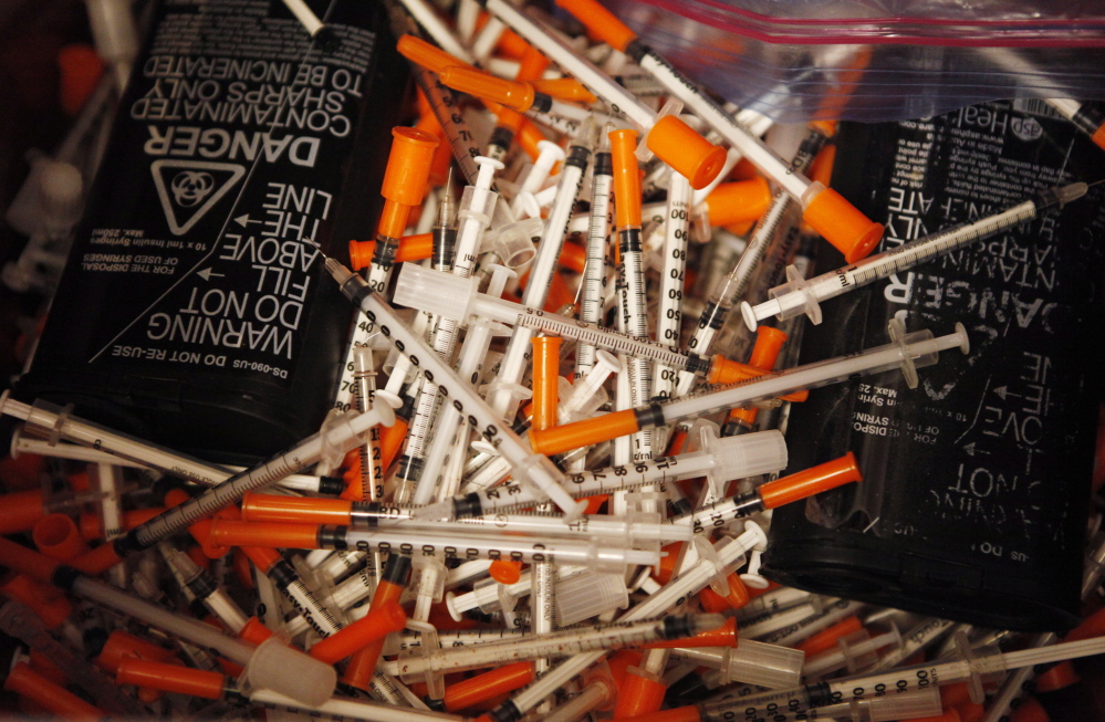 Used hypodermic needles fill a bin at Portland’s India Street Public Health Center needle exchange program, one of several such initiatives around Maine. By containing the spread of hepatitis C, the programs cut down on taxpayer costs: The drugs that can get rid of the virus cost $1,000 a pill.