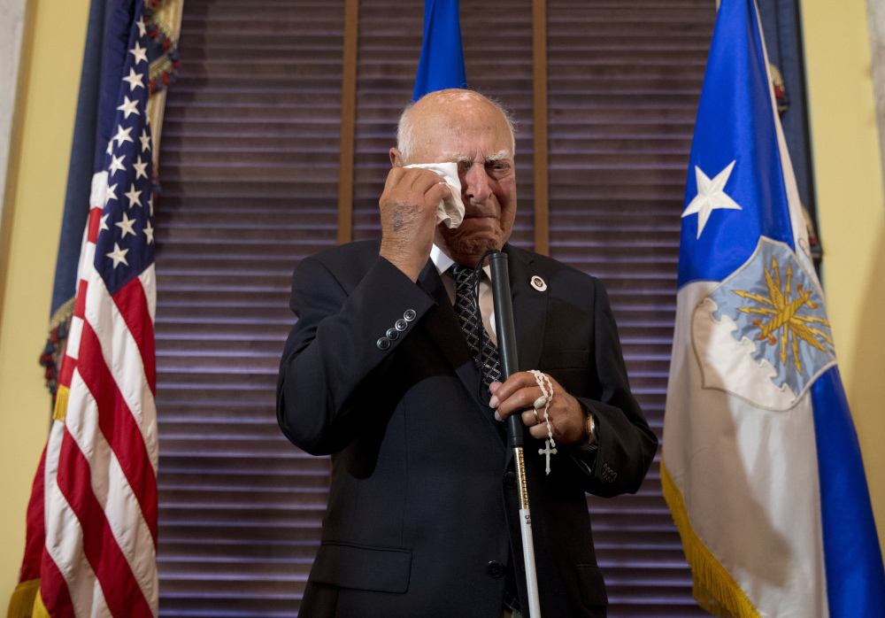 Retired 2nd Lt. John R. Pedevillano, 92, wipes away tears after Sen. John McCain, R-Ariz., honored him with the Presidential Unit Citation with one Oak Leaf Cluster on Tuesday.
