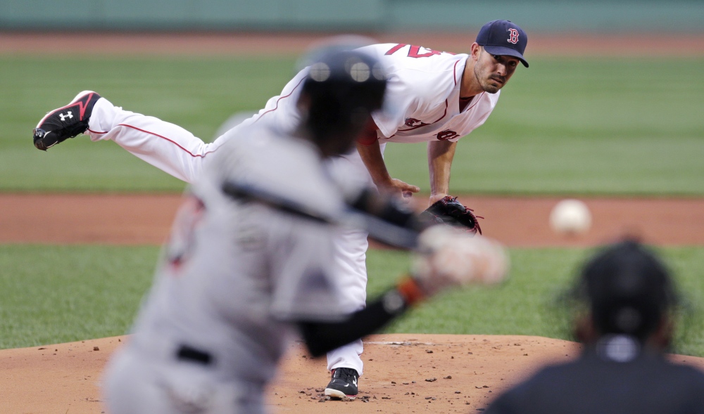 Red Sox starting pitcher Rick Porcello delivers against the Miami Marlins in the first inning Wednesday night at Fenway Park. Porcello pitched six innings and picked up his fifth win of the season, after losing seven straight decisions.